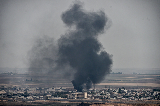 smoke rises from the syrian town of ras al ain in a picture taken from the turkish side of the border in ceylanpinar on october 11 2019 on the third day of turkey 039 s military operation against kurdish forces photo afp