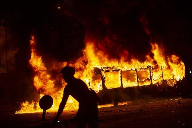 a bus burns down in downtown santiago on october 18 2019 following a mass fare dodging protest photo by claudio reyes photo afp a bus burns down in downtown santiago on october 18 2019 following a mass fare dodging protest photo by claudio reyes photo afp