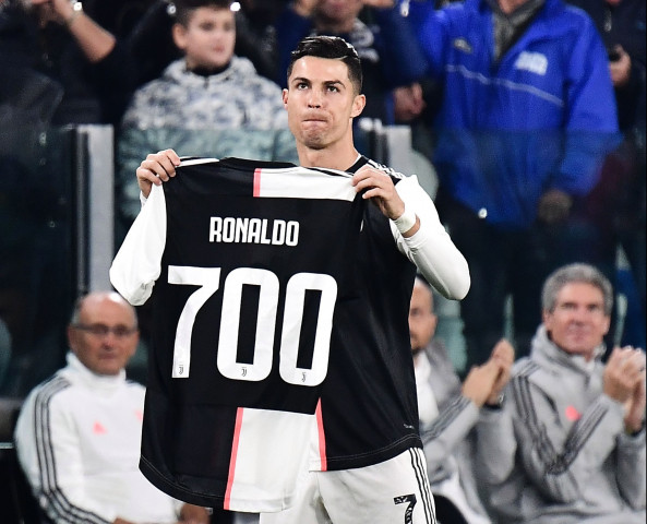 ronaldo was presented with a special jersey before kick off to mark his 700th career goal scored playing for portugal during the week photo afp ronaldo was presented with a special jersey before kick off to mark his 700th career goal scored playing for portugal during the week photo afp