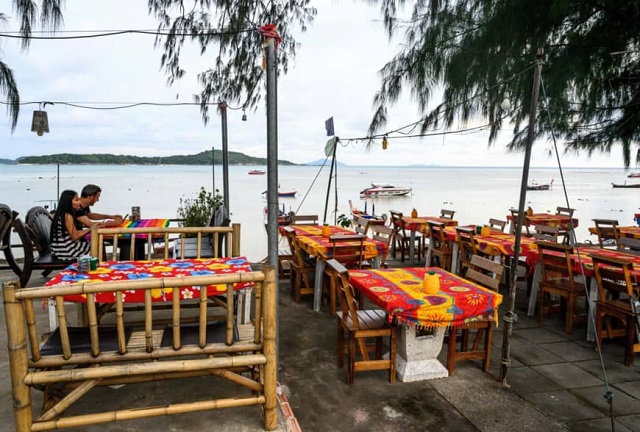 a couple sit at a restaurant on raway beach on phuket island   hotels in thailand 039 s most popular holiday island have been forced to slash prices with rooms left vacant and beaches sparse as tourist chiefs struggle with a plunge in visitors from china caused by the us trade war and stronger baht photo afp