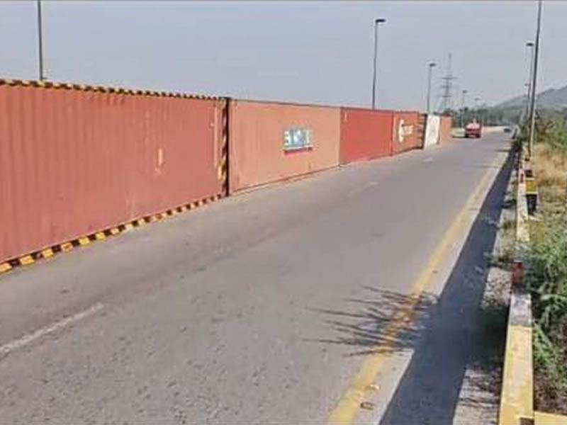 containers placed on a bridge in attock to stop the azadi march photo express