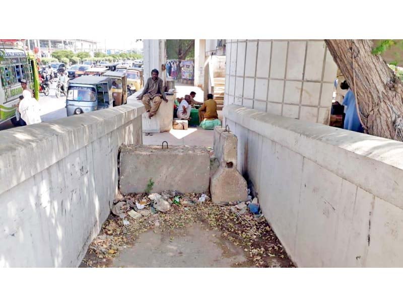 the bridge at natha khan bus stop has been made completely inaccessible for the public as a three foot concrete barrier has been constructed on its ramp photo express