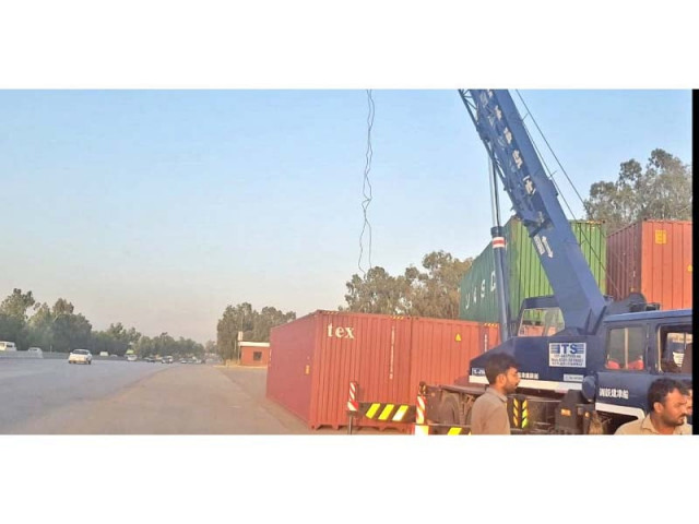 district administration has placed containers near islamabad toll plaza photo express district administration has placed containers near islamabad toll plaza photo express