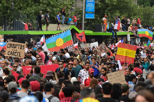 people demonstrate with a mapuche indigenous flag and signs reading quot corrupts to jail quot and quot national referendum chile woke up quot in santiago photo afp