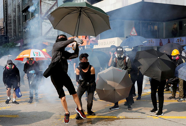 an anti government demonstrator throws back a tear gas canister during a protest march in hong kong china october 20 2019 photo reuters