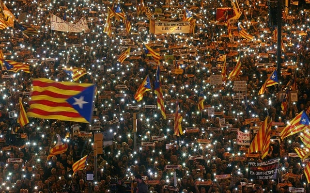 file photo protesters hold the lights of their mobile phones as they wave estelada flags during a demonstration called by pro independence associations asking for the release of jailed catalan activists and leaders in barcelona spain november 11 2017 photo reuters