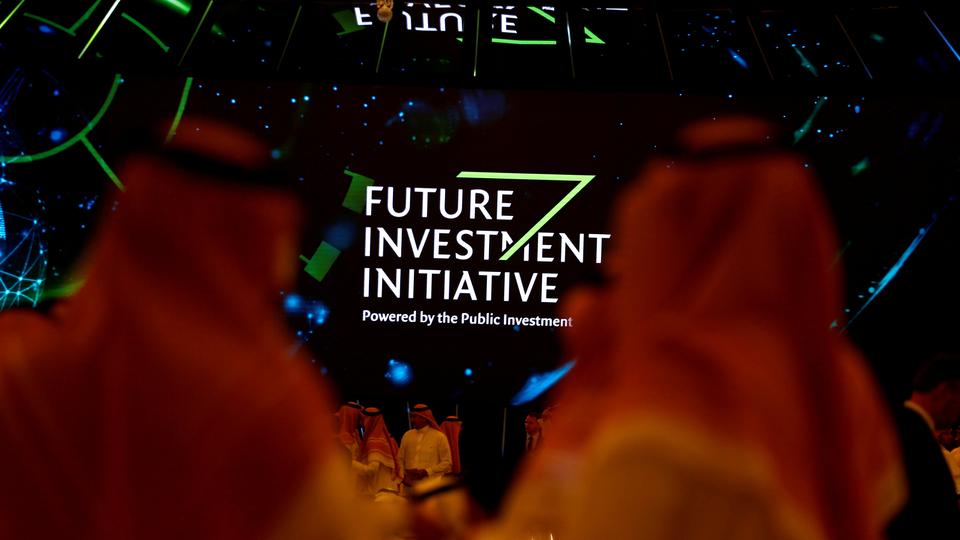 participants look at a sign of the future investment initiative during the investment conference in riyadh saudi arabia october 23 2018 photo reuters