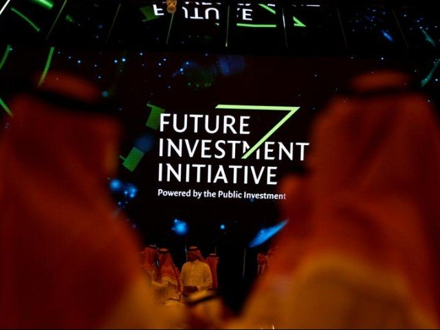 participants look at a sign of the future investment initiative during the investment conference in riyadh saudi arabia october 23 2018 photo reuters