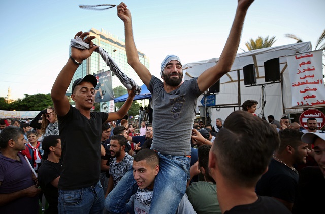 protesters celebrate after the prime minister saad al hariri announced his resignation in sidon lebanon photo reuters
