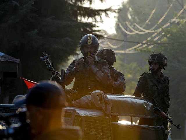 security personnel stand guard as members of a european lawmakers delegation are being transported towards a hotel during a lockdown in srinagar on october 29 2019 photo afp
