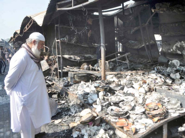 a man looks at his burnt stall after the fire at the sector h 9 sunday bazaar photo zafar aslam express a man looks at his burnt stall after the fire at the sector h 9 sunday bazaar photo zafar aslam express