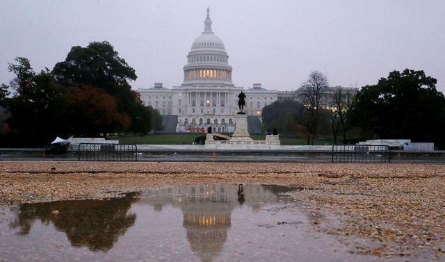 the us capitol building is seen reflected in a puddle at sunrise on the day of the u s midterm election as voters go to the polls across the country to elect 33 u s senators and all 435 members of the us house of representatives in washington u s november 6 2018 photo reuters