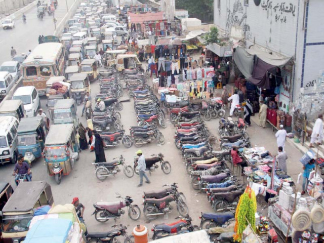an illegal charged parking site has blocked more than half the road at the liaquatabad supermarket causing traffic jams on an almost daily basis photo online an illegal charged parking site has blocked more than half the road at the liaquatabad supermarket causing traffic jams on an almost daily basis photo online