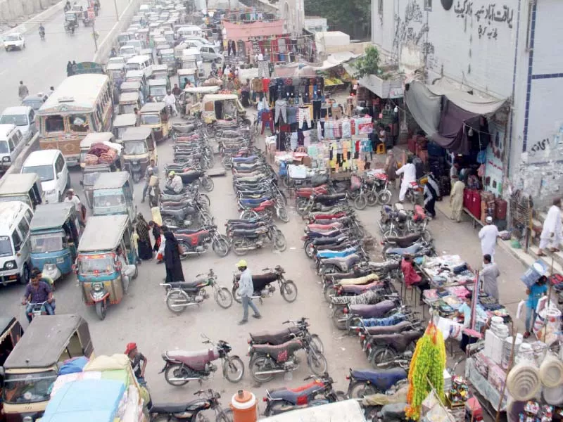 an illegal charged parking site has blocked more than half the road at the liaquatabad supermarket causing traffic jams on an almost daily basis photo online an illegal charged parking site has blocked more than half the road at the liaquatabad supermarket causing traffic jams on an almost daily basis photo online