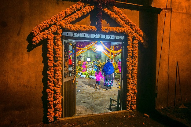 a woman and a young girl look at offerings for the celebration of the day of the dead in santa fe de la laguna village quiroga municipality michoacan state on october 31 2019 photo afp