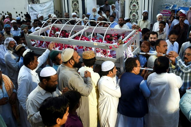 the first funerals began of some of those killed when a passenger train caught fire in pakistan photo afp