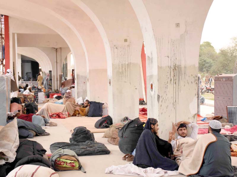 a man makes tea while azadi march participants rest in the closed metro bus station photos online