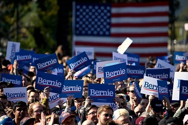 supporters of us presidential hopeful bernie sanders hold signs during a campaign rally on oct 19 2019 in new york city photo afp