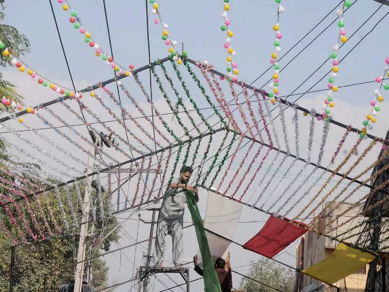 a man decorating a street in dhoke chiragh din for eid miladun nabi pbuh celebrations photo nni a man decorating a street in dhoke chiragh din for eid miladun nabi pbuh celebrations photo nni