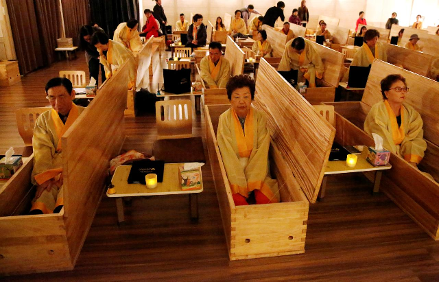 participants sit inside coffins during a quot living funeral quot event as part of a quot dying well quot programme in seoul photo reuters