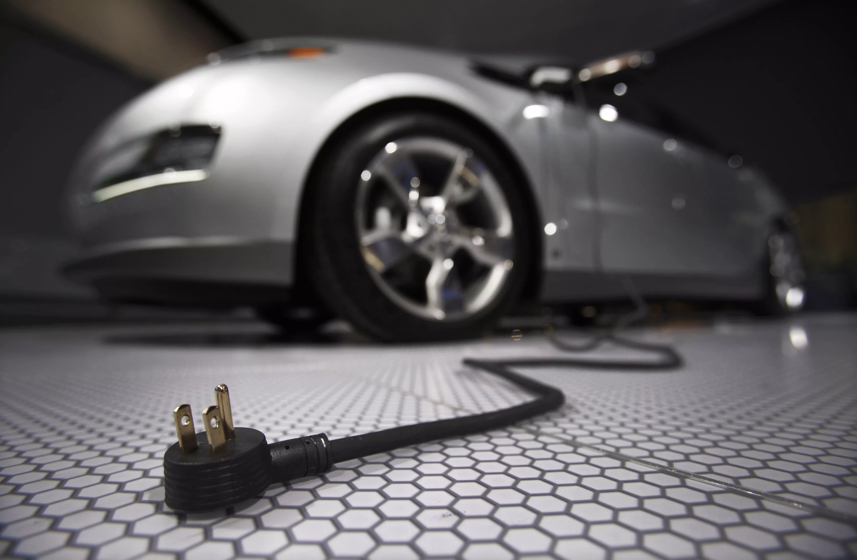 a plug is seen coming from an electric car during the north american international auto show in detroit michigan photo reuters a plug is seen coming from an electric car during the north american international auto show in detroit michigan photo reuters
