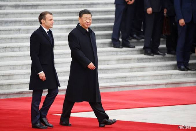 xi macron vow to expand cooperation reaffirm support for climate pact photo reuters