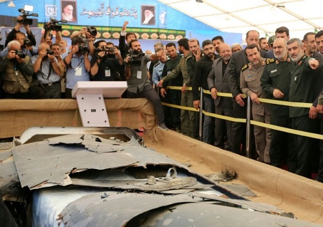 iran has put what it says is the debris of a us drone it shot down over the gulf in june on display in a special exbition in tehran photo afp file