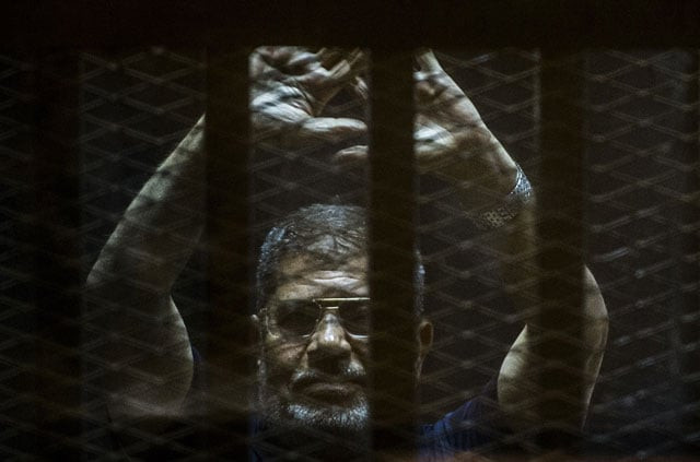 a file picture taken on june 2 2015 shows ousted egyptian president mohamed morsi gesturing from the defendants cage as he attends his trial at the police academy on the outskirts of the capital cairo photo afp a file picture taken on june 2 2015 shows ousted egyptian president mohamed morsi gesturing from the defendants cage as he attends his trial at the police academy on the outskirts of the capital cairo photo afp