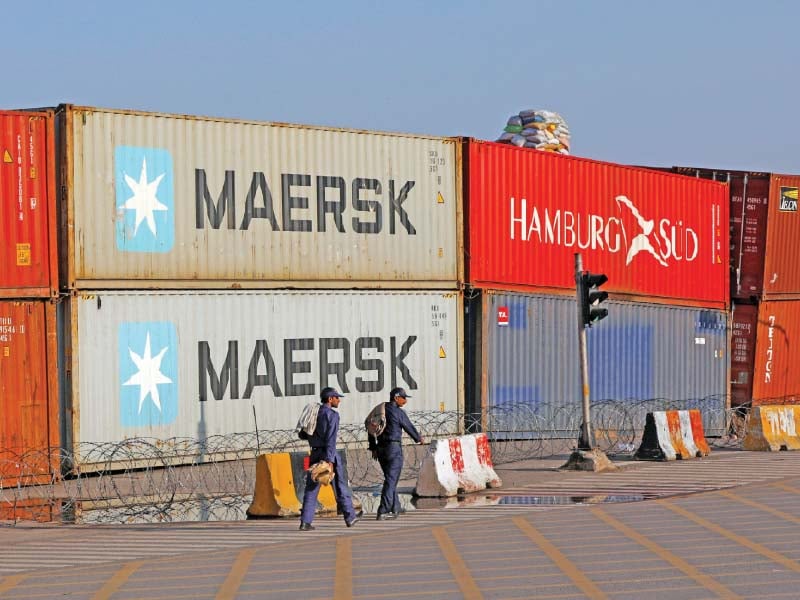 security officials walk past containers blocking a road leading towards red zone in islamabad photo reuters