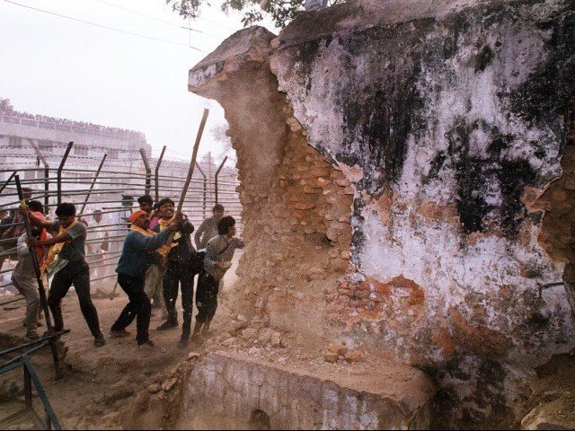 in this december 6 1992 photograph rioters attack the wall of the 16th century babri masjid mosque with iron rods at a disputed holy site in the city of ayodhya photo afp