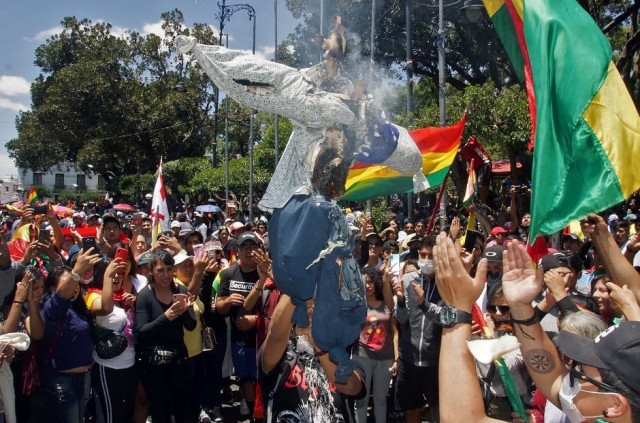 opponents to bolivian president evo morales hold a bolivian national flag next to a bonfire during a protest photo afp opponents to bolivian president evo morales hold a bolivian national flag next to a bonfire during a protest photo afp