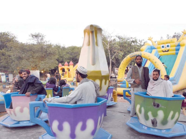azadi march participants take a break to enjoy rides at a recreation park in islamabad photo online azadi march participants take a break to enjoy rides at a recreation park in islamabad photo online