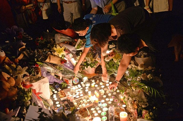 mourners light candles during a vigil at the site of a knife attack which left two children dead in shanghai in 2018 photo afp mourners light candles during a vigil at the site of a knife attack which left two children dead in shanghai in 2018 photo afp