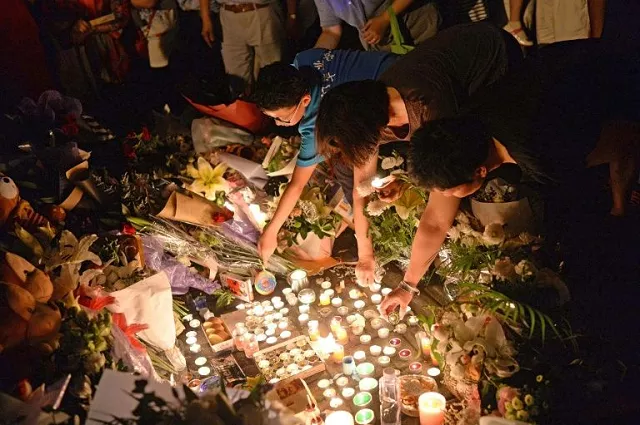 mourners light candles during a vigil at the site of a knife attack which left two children dead in shanghai in 2018 photo afp mourners light candles during a vigil at the site of a knife attack which left two children dead in shanghai in 2018 photo afp