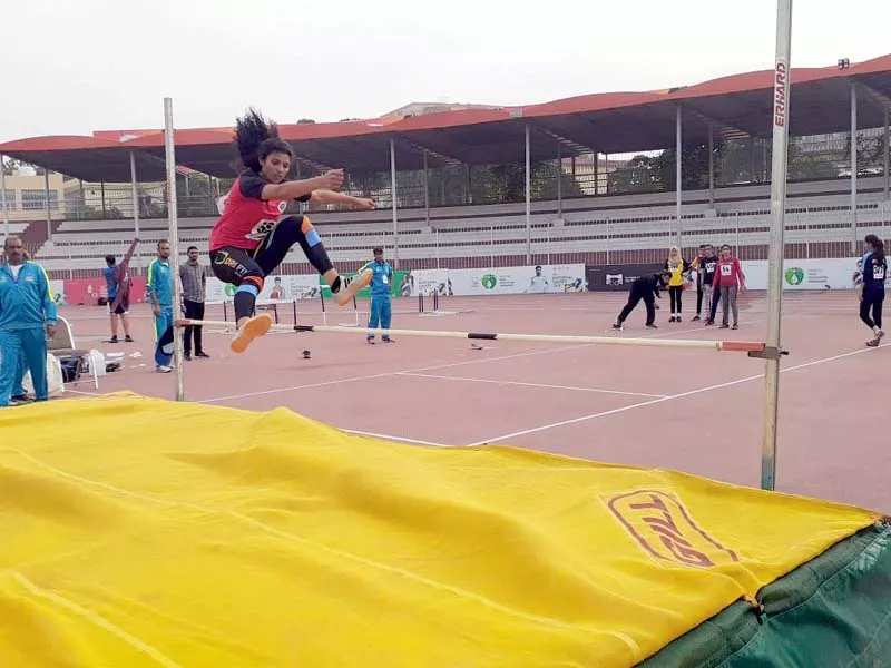an athlete performs a high jump during the national games photo express