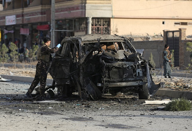 a member of the afghan security forces inspects the site of a suicide blast in kabul photo reuters