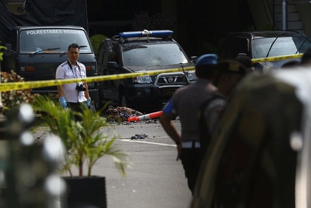 police keep watch near the blast location after a suspected suicide bombing outside the police headquarters in medan photo reuters police keep watch near the blast location after a suspected suicide bombing outside the police headquarters in medan photo reuters