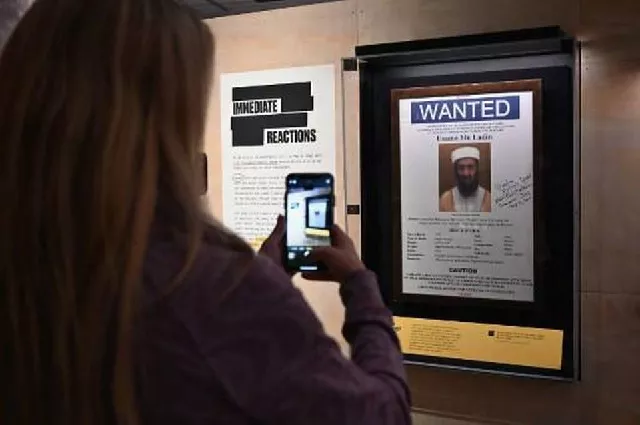 a woman takes a picture of an osama bin laden wanted poster at the quot revealed the hunt for bin laden quot exhibition at the national 9 11 memorial museum photo afp a woman takes a picture of an osama bin laden wanted poster at the quot revealed the hunt for bin laden quot exhibition at the national 9 11 memorial museum photo afp