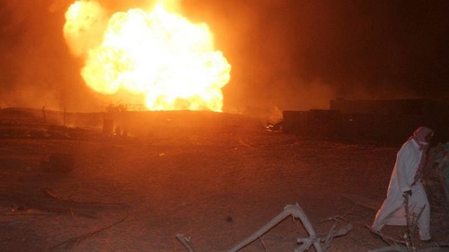 an egyptian man walks in the vicinity of a fire ball following an attack by saboteurs on an egyptian gas pipeline on july 12 2011 at al arish in sinai photo afp