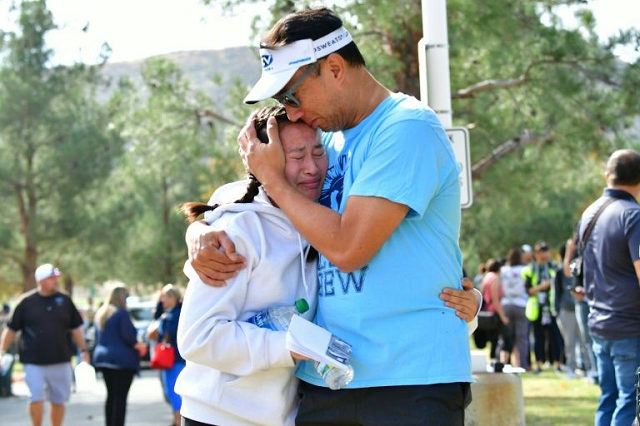 a man embraces his daughter after a shooting at saugus high school in santa clarita california photo afp