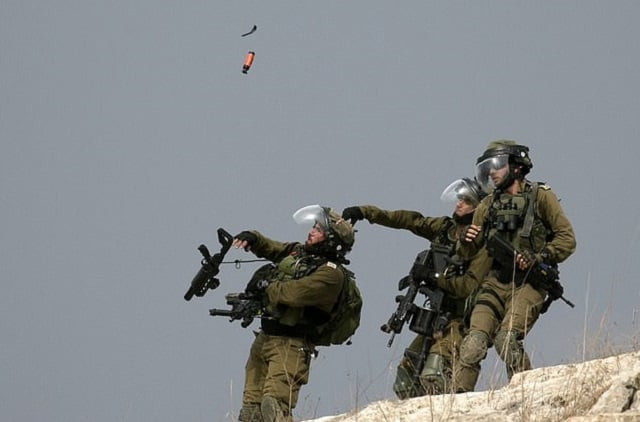 an israeli soldier throws a tear gas canister at palestinian protesters during clashes with them following a weekly demonstration against the expropriation of palestinian land by israel in the village of kfar qaddum photo afp an israeli soldier throws a tear gas canister at palestinian protesters during clashes with them following a weekly demonstration against the expropriation of palestinian land by israel in the village of kfar qaddum photo afp