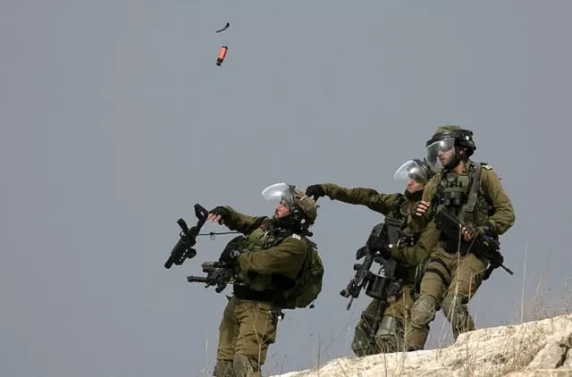 an israeli soldier throws a tear gas canister at palestinian protesters during clashes with them following a weekly demonstration against the expropriation of palestinian land by israel in the village of kfar qaddum photo afp an israeli soldier throws a tear gas canister at palestinian protesters during clashes with them following a weekly demonstration against the expropriation of palestinian land by israel in the village of kfar qaddum photo afp