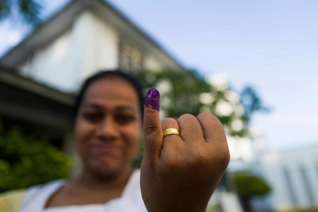 a woman shows her inked finger outside a polling station after casting her vote during the country 039 s presidential election in colombo photo afp a woman shows her inked finger outside a polling station after casting her vote during the country 039 s presidential election in colombo photo afp