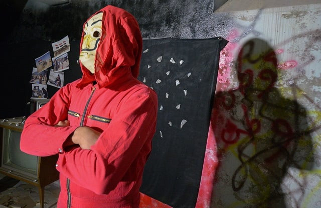 an iraqi youth donning the red jumpsuit and dali mask of the spanish netflix hit series la casa de papel money heist stands cross armed as he performs in a video clip in arabic using the music of the famous song quot bella ciao quot in the northern city of mosul photo afp an iraqi youth donning the red jumpsuit and dali mask of the spanish netflix hit series la casa de papel money heist stands cross armed as he performs in a video clip in arabic using the music of the famous song quot bella ciao quot in the northern city of mosul photo afp