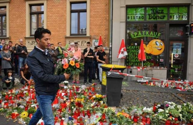 ismet an employee in the 039 kiez doener 039 lays down a bunch of flowers at a makeshift memorial of candles and flowers for the victims of a deadly shooting during an attack targeting the turkish restaurant after an attempt at a synagogue on october 13 2019 in halle eastern germany photo afp ismet an employee in the 039 kiez doener 039 lays down a bunch of flowers at a makeshift memorial of candles and flowers for the victims of a deadly shooting during an attack targeting the turkish restaurant after an attempt at a synagogue on october 13 2019 in halle eastern germany photo afp