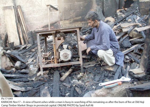 a vendor at the timber market in old haji camp looks for something to salvage from the remains of the merchandise which was largely engulfed in flames on sunday as the fire ravaged eight shops and two warehouses photo online a vendor at the timber market in old haji camp looks for something to salvage from the remains of the merchandise which was largely engulfed in flames on sunday as the fire ravaged eight shops and two warehouses photo online