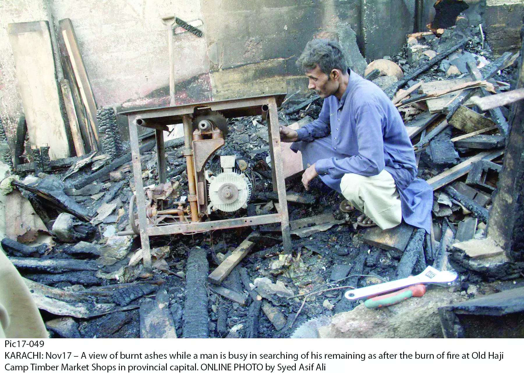 a vendor at the timber market in old haji camp looks for something to salvage from the remains of the merchandise which was largely engulfed in flames on sunday as the fire ravaged eight shops and two warehouses photo online a vendor at the timber market in old haji camp looks for something to salvage from the remains of the merchandise which was largely engulfed in flames on sunday as the fire ravaged eight shops and two warehouses photo online