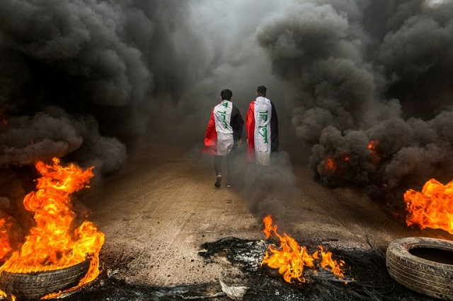 anti government protesters set tyres on fire to block roads in iraq 039 s southern city of basra photo afp