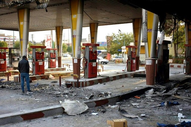 an iranian man checks a scorched gas station that was set ablaze by protesters during a demonstration against a rise in gasoline prices in eslamshahr near the iranian capital of tehran on november 17 2019 photo afp