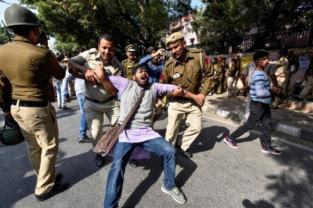 security personnel hold a jawaharlal nehru university jnu student during a students protest against hostel fee hike as security measures have been reinforced from jnu campus along the road to the march protest in new delhi on november 18 2019 photo afp security personnel hold a jawaharlal nehru university jnu student during a students protest against hostel fee hike as security measures have been reinforced from jnu campus along the road to the march protest in new delhi on november 18 2019 photo afp